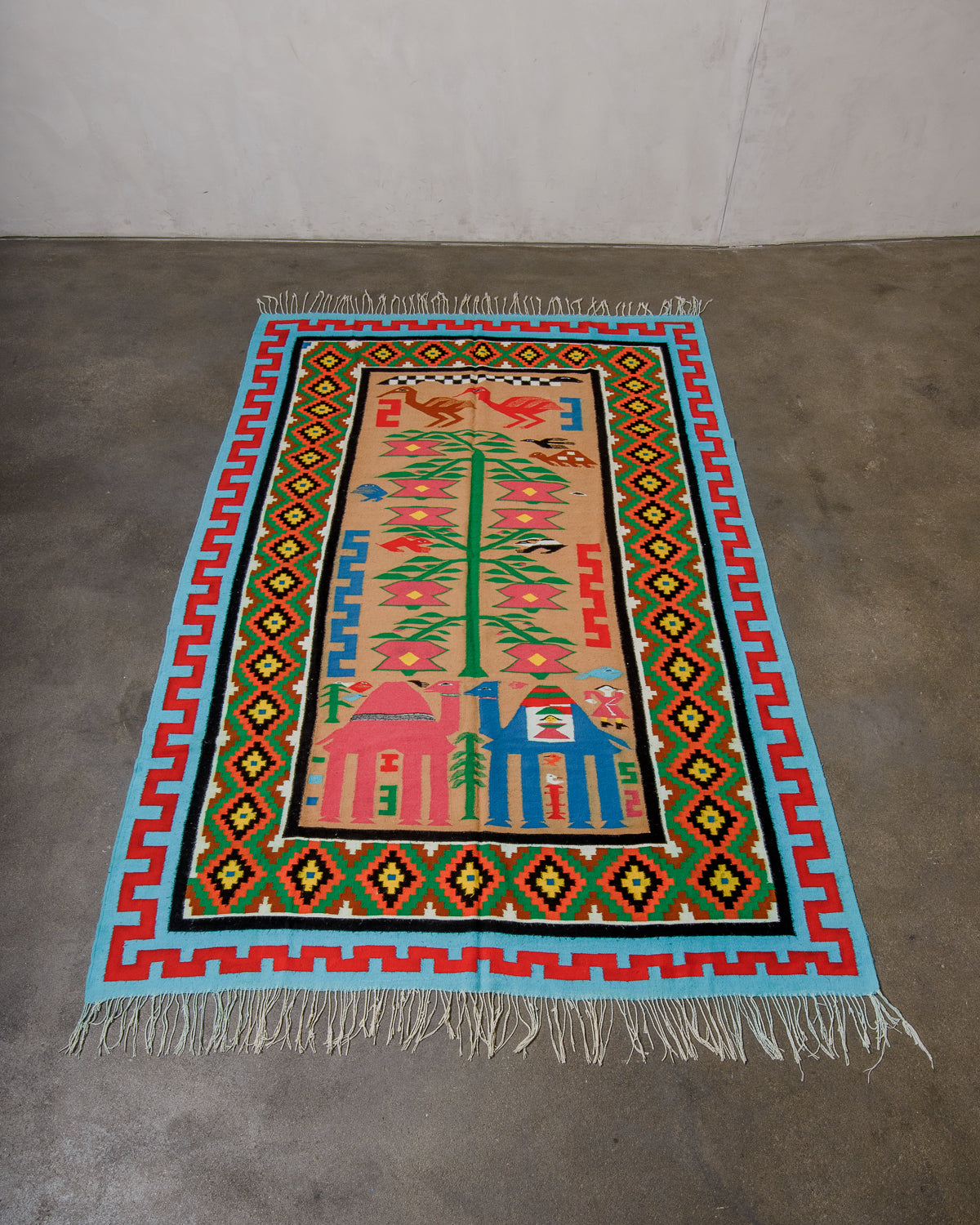 Colorful patterned rug with geometric design on a plain background